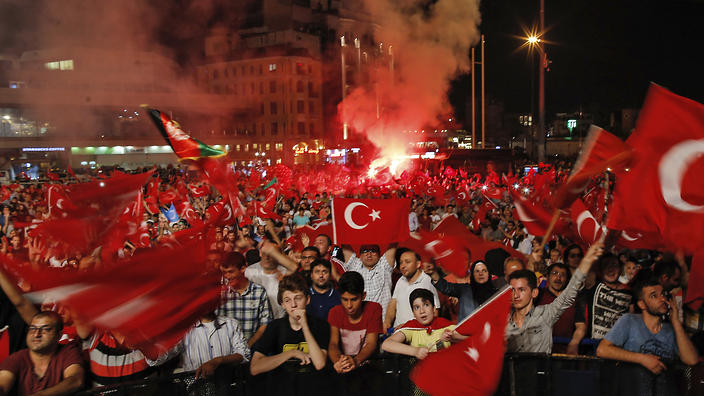 People wave Turkish flags as they gather in Taksim Square in Istanbul protesting against the attempted coup early Tuesday