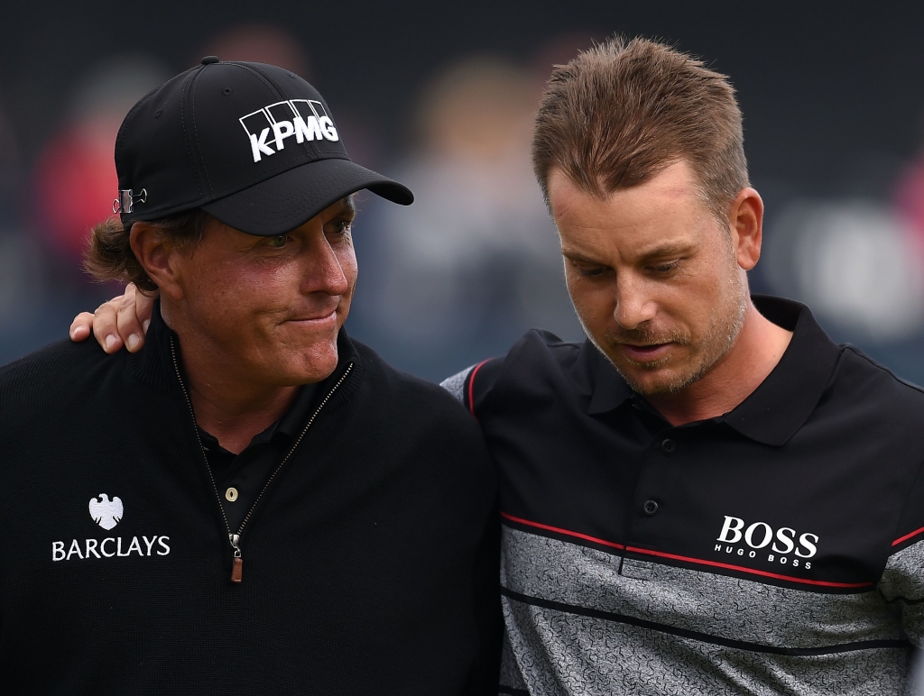 Winner Sweden's Henrik Stenson consoles runner-up US golfer Phil Mickelson on the 18th green after shooting 63 in his final round to win the Championship on day four of the 2016 British Open Golf Championship at Royal Troon in Scotland on July 1