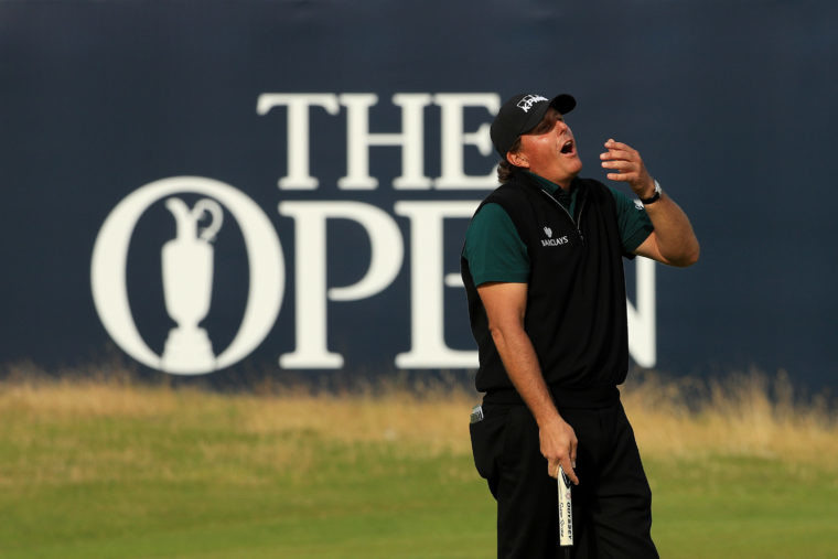 Phil Mickelson of the United States reacts after his birdie putt narrowly missed the hole on the 18th