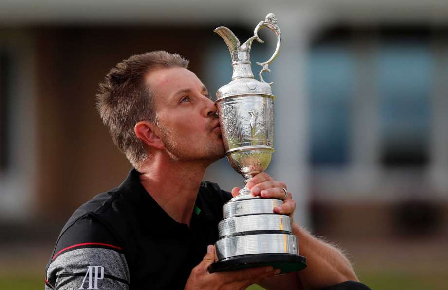 Henrik Stenson of Sweden kisses the trophy after winning the British Open Golf Championships at the Royal Troon Golf Club in Troon Scotland Sunday