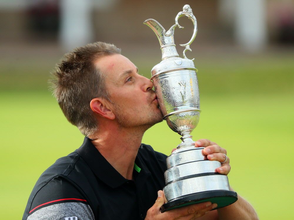 Henrik Stenson of Sweden celebrates victory as he poses with the Claret Jug on the the 18th green after the final round on day four of the 145th Open Championship at Royal Troon