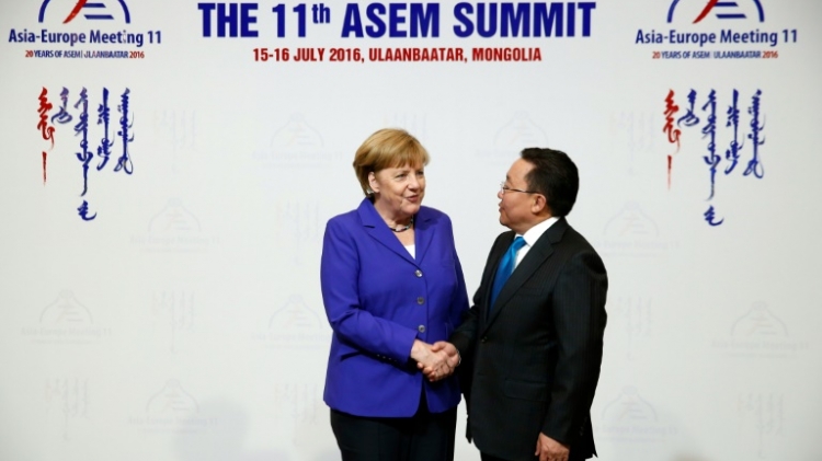 German Chancellor Angela Merkel meets Mongolian President Tsakhiagiin Elbegdorj on her arrival in Ulan Bator for the Asia Europe Meeting