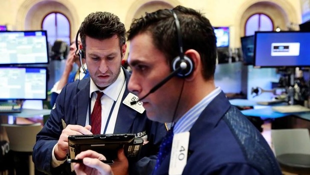 Traders work on the floor of the New York Stock Exchange shortly after the opening bell in New York | Reuters