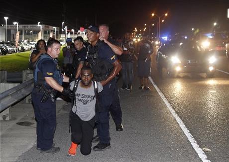 Police arrest activist De Ray McKesson during a protest along Airline Highway a major road that passes in front of the Baton Rouge Police Department headquarters Saturday