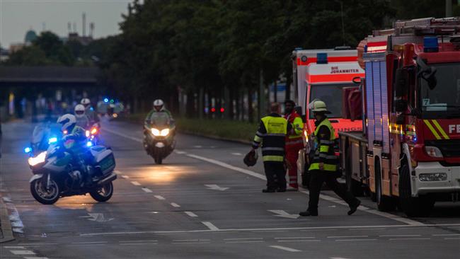 Police and firefighters are seen near the Olympia Einkaufzentrum shopping mall in Munich