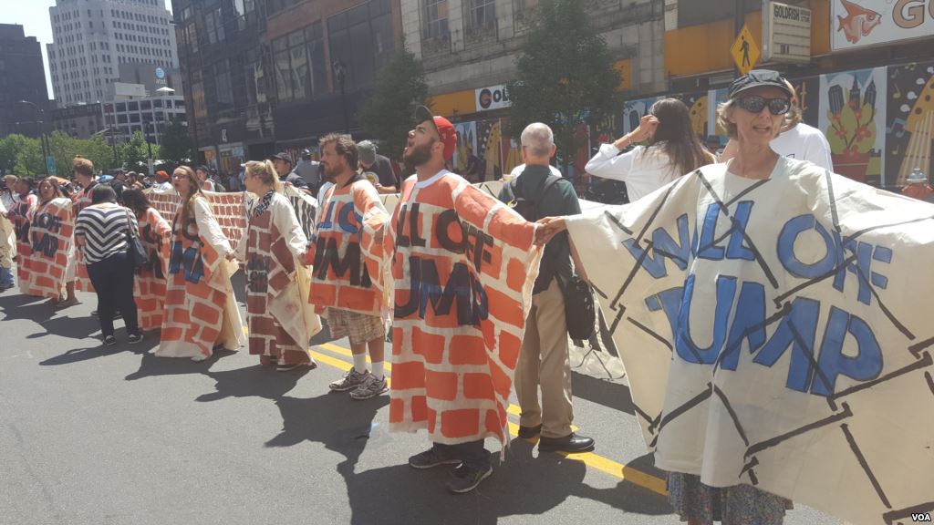 Unidentified protesters form a'wall against Trump's hate outside the Republican National Convention in Cleveland Ohio