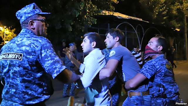 Police detain protesters following clashes in Yerevan on the night of July 29