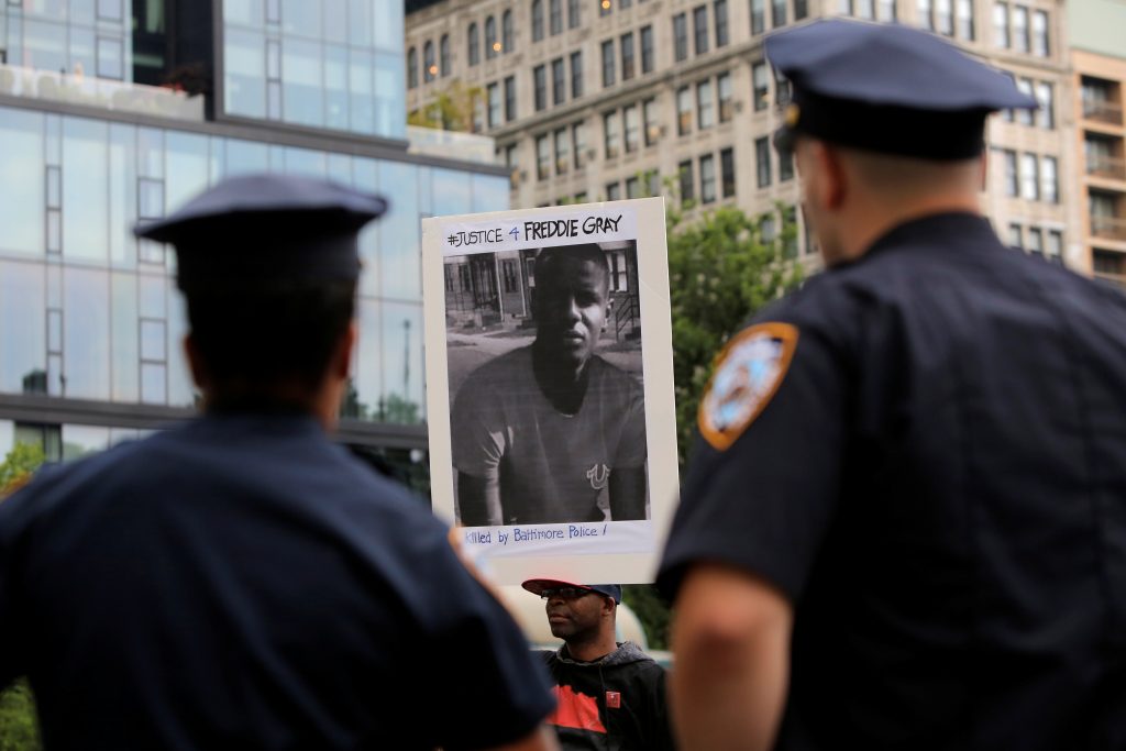 Police observe a protest on June 23 in Baltimore over the death of Freddie Gray while he was in police custody