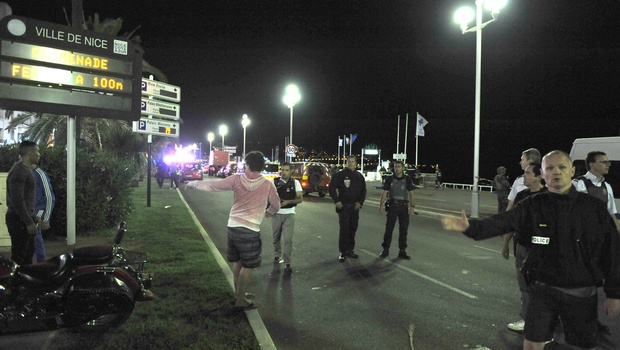 Police officers secure the scene of an attack in the French resort city of Nice southern France Friday