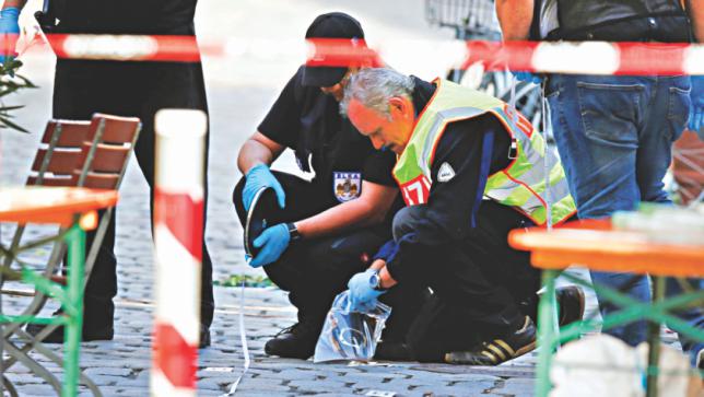 Police secure the area after an explosion in Ansbach Germany yesterday