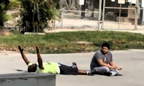 A screengrab from footage showing therapist Charles Kinsey with his hands up on the ground. Throughout the ordeal he tries to soothe his autistic patient, who was playing with a toy truck