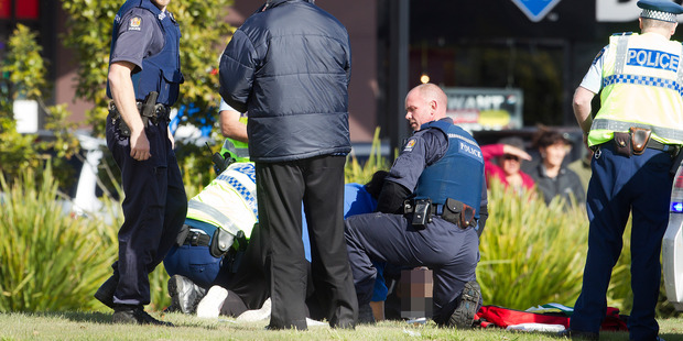 Police attend to the shooting victim