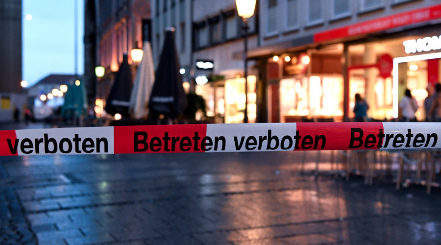 Police sign blocks the entrance to Odeon square following shootings at a shopping mall earlier