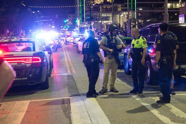 Police stand near a baracade following the shooting in Dallas