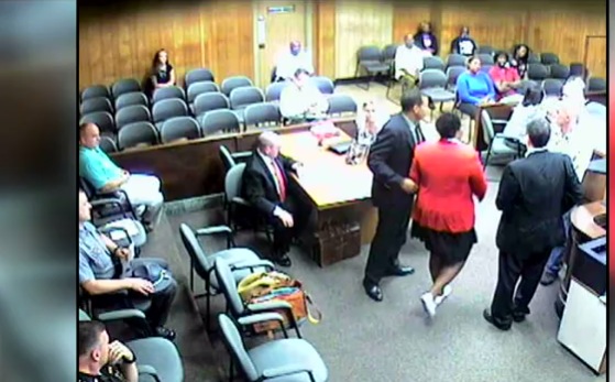 Attorney Andrea Burton being removed from court by a bailiff for wearing a Black Lives Matter button. The judge of the courtroom sentenced her to five days in jail for being in contempt