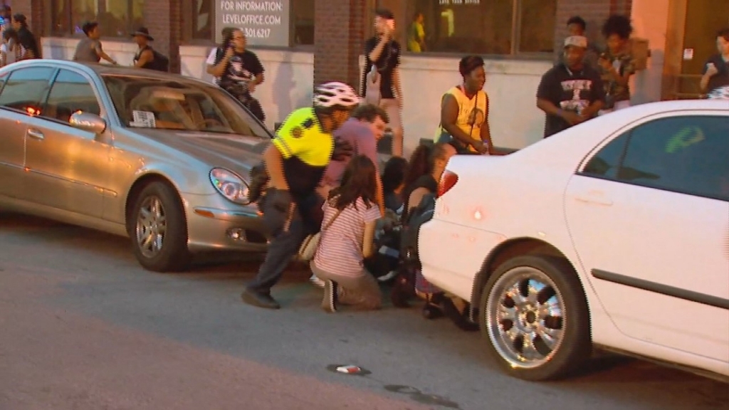 Police urge civilians to take cover after shots were fired at a protest in Dallas Thursday night