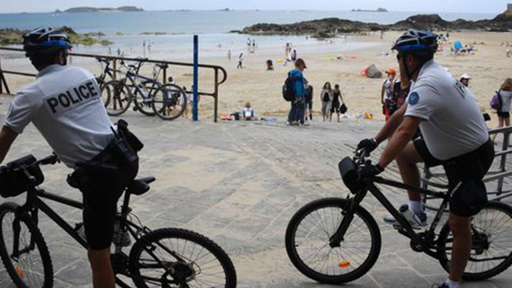 Policemen patrol on bike close to the beach of Saint-Malo western France