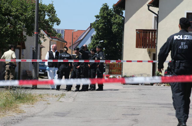 Policemen stand at a crime scene in Tiefenthal Leutershausen near Ansbach southern Germany