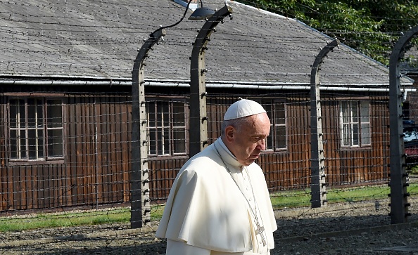 Pope Francis walks through the entrance of the former Nazi death camp of Auschwitz in Oswiecim on 29 July 2016