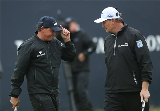 Phil Mickelson of the United States left smiles with Ernie Els of South Africa on the 18th green after he completes his second round of the British Open Golf Championship at the Royal Troon Golf Club in Troon Scotland Fr