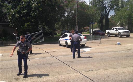 Baton Rouge police officers man a roadblock at Old Hammond Highway and Tara Boulevard after multiple officers were shot Sunday. Baton Rouge Louisiana