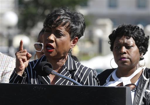 TV Judge Glenda Hatchett left addresses the media as Valerie Castile the mother of Philando Castile listens during a news conference on the State Capitol grounds Tuesday