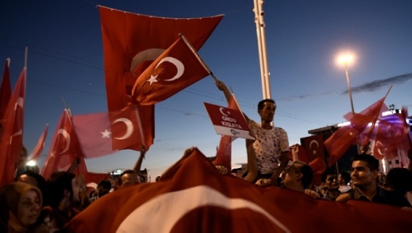 Pro-Erdogan supporters wave Turkish flags during a rally against the Jul 15 military coup at Taksim square in Istanbul