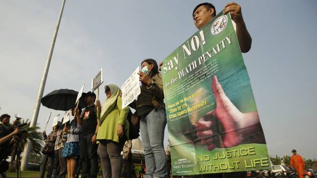 Protesters attend a rally against the death penalty outside the presidential palace in Jakarta