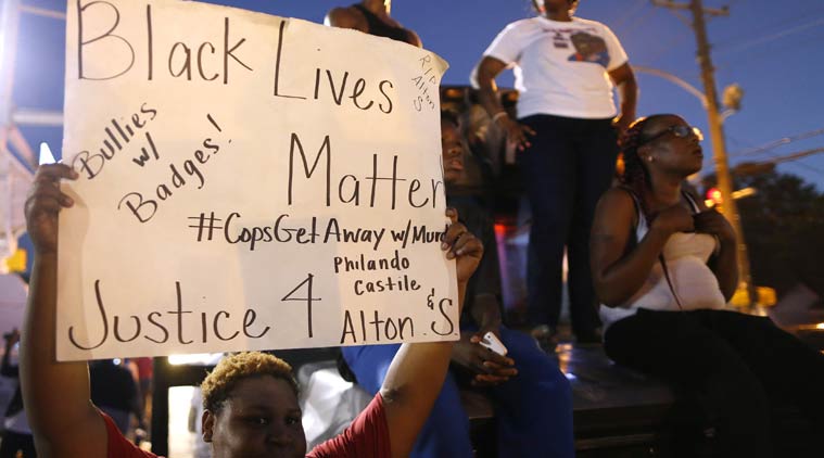 Protesters demonstrate outside the Triple S Food Mart where Alton Sterling was shot dead by police in Baton Rouge Louisiana