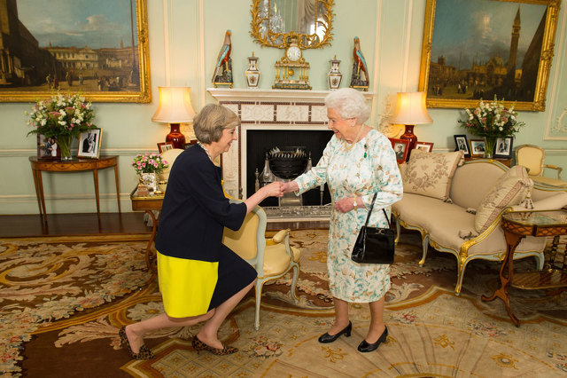 Queen Elizabeth II welcomed Theresa May left Wednesday in Buckingham Palace London. Click