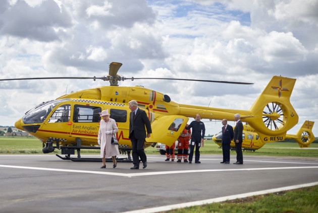 Queen Elizabeth II and the Duke of Edinburgh with their grandson the Duke of Cambridge, as they open the new base of East Anglian Air Ambulance at Cambridge Airport. Niklas Halle