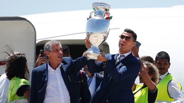 Portugal's head coach Fernando Santos and Cristiano Ronaldo step off their plane holding the Euro 2016 cup