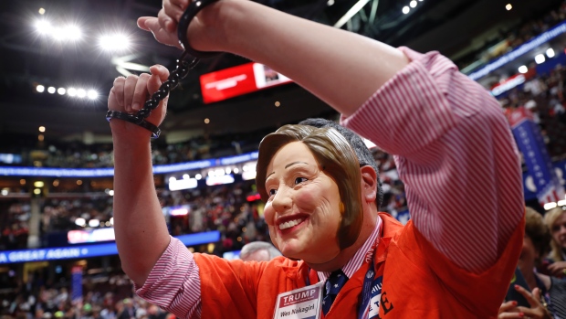 A delegate wearing a mask of Democratic presidential candidate Hillary Clinton as well as handcuffs and a prison jumpsuit appears on the convention floor before the start of the final day of the Republican National Convention in Cleveland