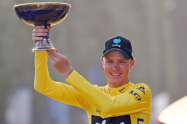 Chris Froome lifts the trophy after his record victory in the Tour de France