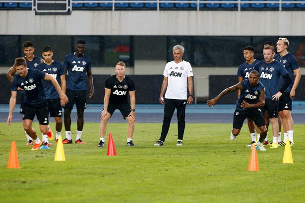 Jose Mourinho watches his players during training