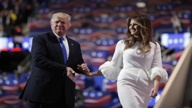 Republican presidential candidate Donald Trump walks off the stage with his wife Melania during the Republican National Convention Monday