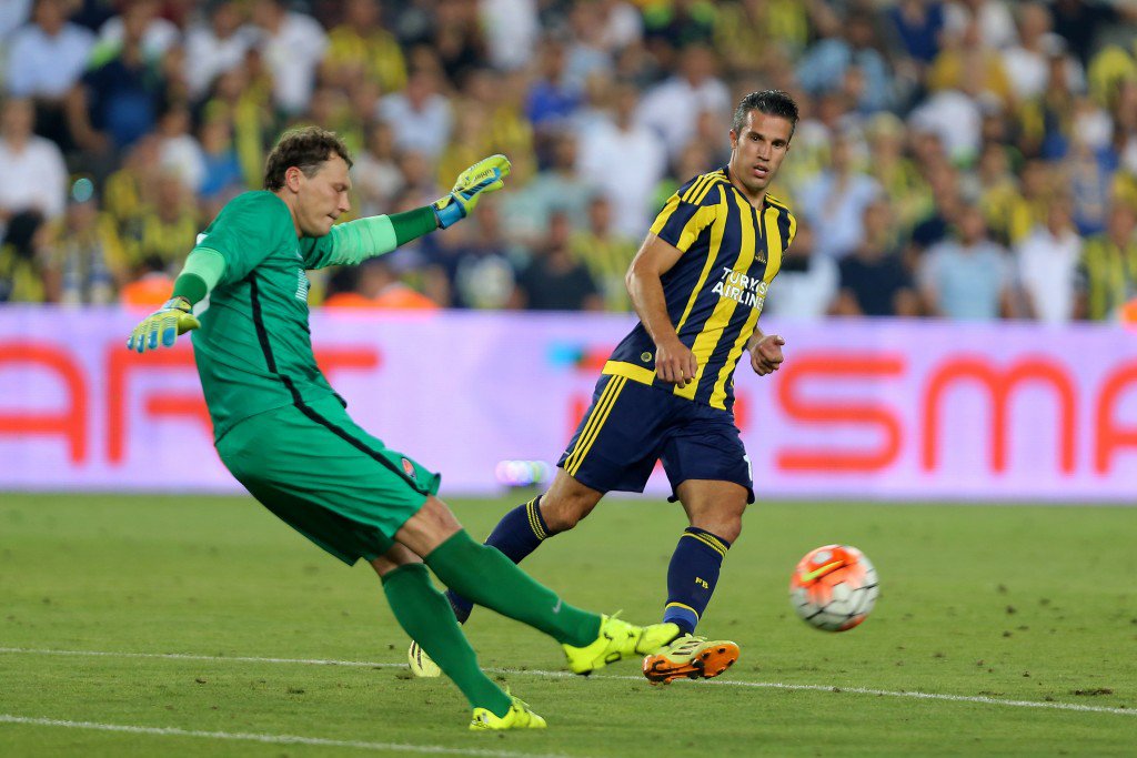 ISTANBUL TURKEY- JULY 28 Robin van Persie of Fenerbahce is in action with Andriy Pyatov of Shaktar Donetsk during UEFA Champions League Third Qualifying Round 1st Leg match betweeen Fenerbahce v Shakhtar Donetsk at Sukru Saracoglu Stadium