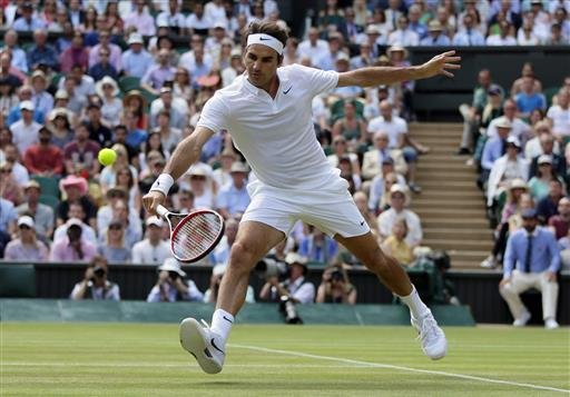 Roger Federer of Switzerland plays a return to Marin Cilic of Croatia during their men's singles match on day ten of the Wimbledon Tennis Championships in London Wednesday