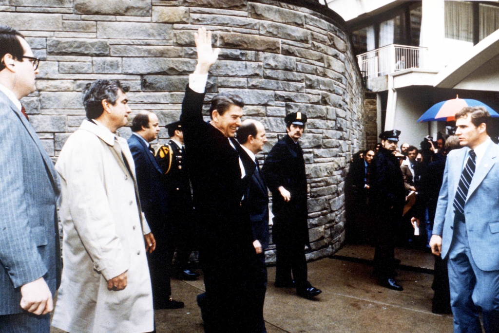 President Ronald Reagan waves to onlookers moments before an assassination attempt by John Hinckley Jr