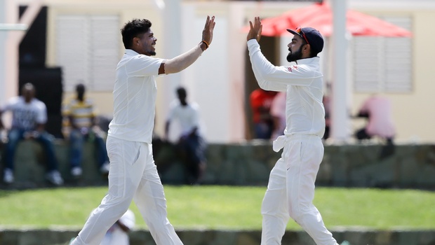 India's bowler Umesh Yadav left celebrates with captain Virat Kohli taking the wicket of West Indies Kraigg Brathwaite during day three of their first cricket Test match at the Sir Vivian Richards Stadium in North Sound Antigua Saturday