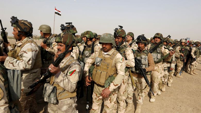 Iraqi security forces wait for vehicles travelling to Mosul to fight against Daesh militants at an Iraqi army base in Camp Taji in Baghdad. Thousands are fleeing the northern Iraqi town of Shirqat controlled by Daesh before a planned government assault