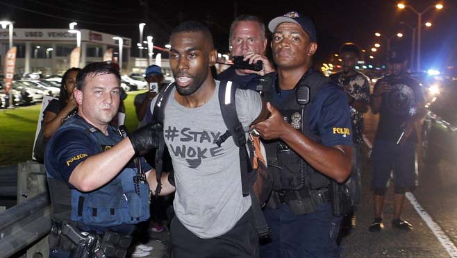 Police arrest activist De Ray McKesson during a protest along Airline Highway a major road that passes in front of the Baton Rouge Police Department headquarters Saturday