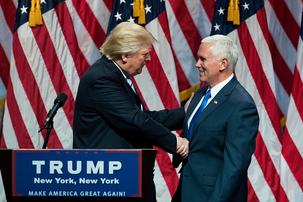 Republican presidential candidate Donald Trump shakes hands with his newly selected vice presidential running mate Mike Pence governor of Indiana during an event at the Hilton Midtown Hotel