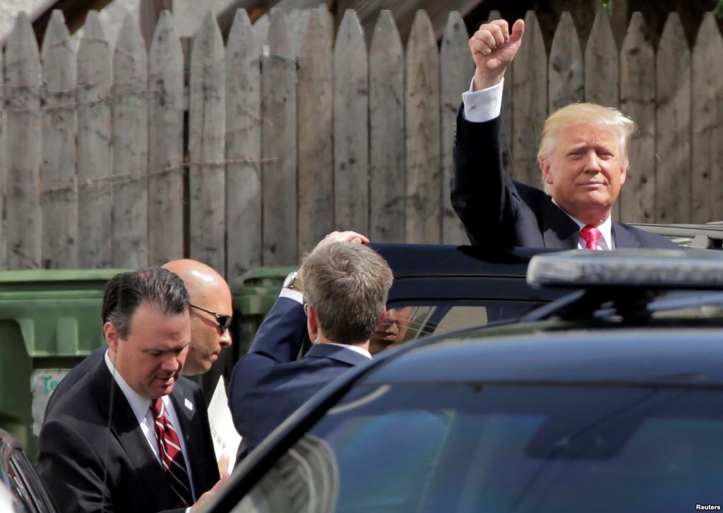 Republican U.S. presidential candidate Donald Trump waves after meeting with House Republican members in Washington