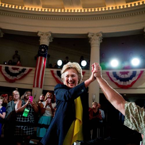 Democratic presidential candidate Hillary Clinton high fives a member of the audience as she arrives to speak at the Old State House in Springfield Ill. Clinton's campaign is launching a