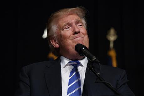 Republican presidential candidate Donald Trump smiles during a town hall Monday