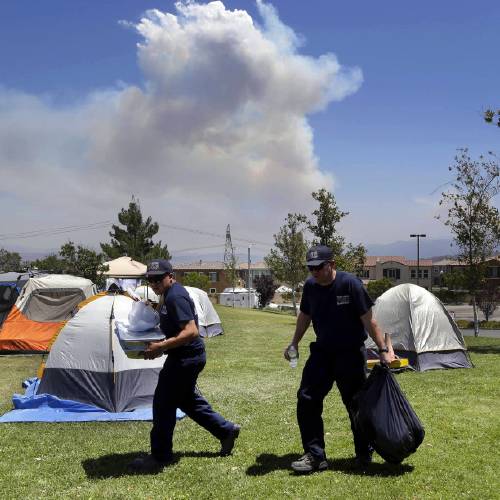 The Latest: Weather aids firefighters on California coast