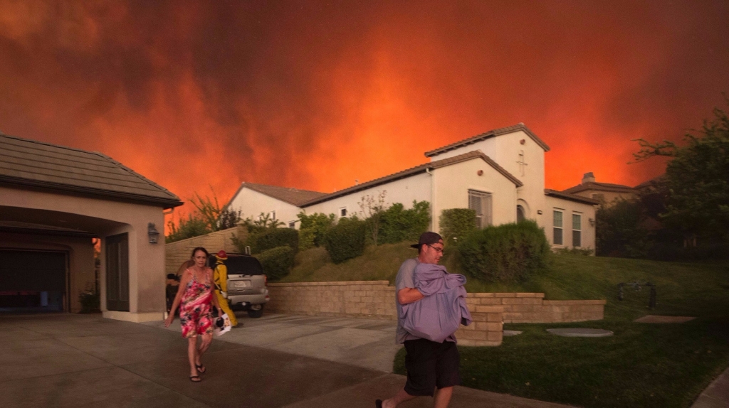 Residents evacuate from the Sand Fire