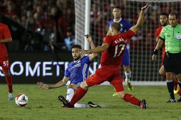 Chelsea's Cesc Fabregas in action with Liverpool's Ragnar Klavan before he gets a red card