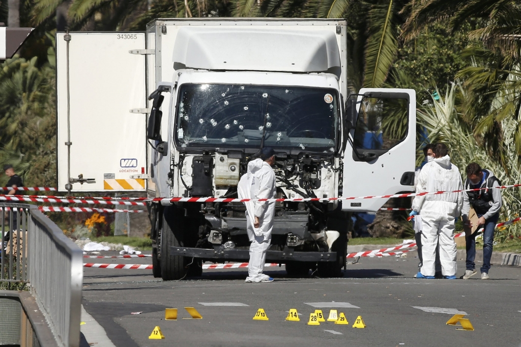 Investigators continue to work at the scene near the truck that was driven into a crowd at high speed killing scores who were celebrating Bastille Day on July 14 on the Promenade des Anglais in Nice France